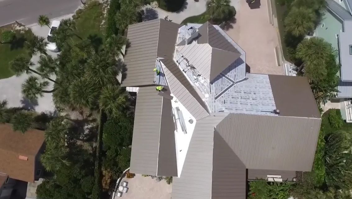 An aerial view of a house with a roof being installed.