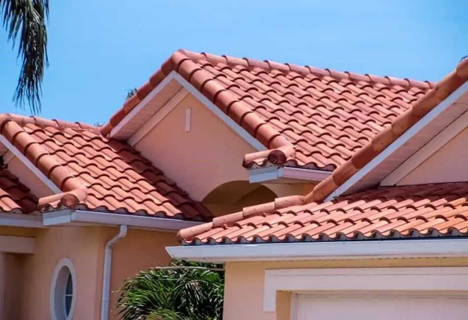 A close up of a house with a red tile roof.