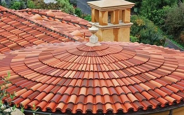 A circular roof with a chimney on top of it