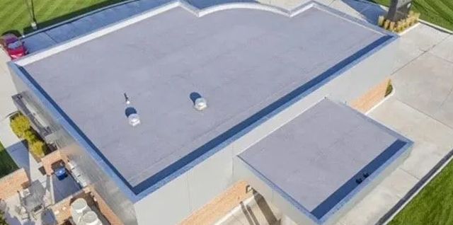 An aerial view of a building with a gray roof