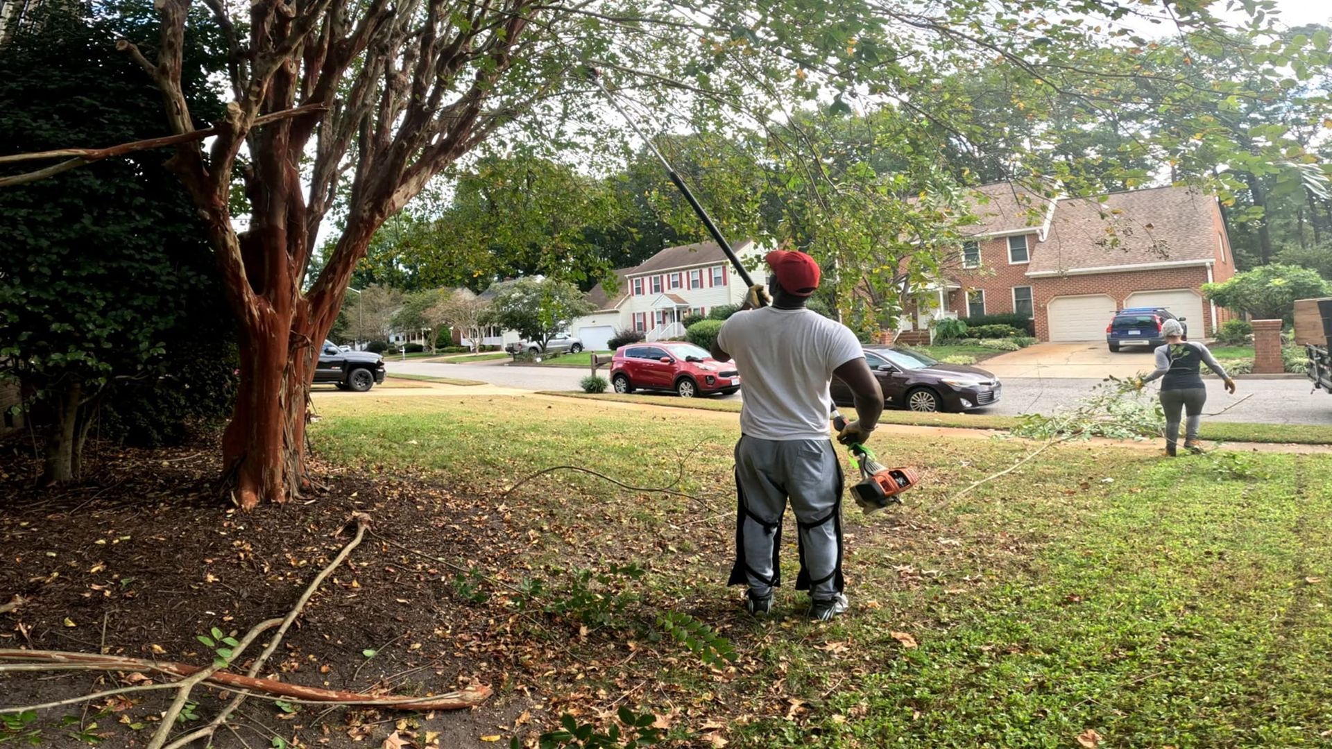 a man is using a lawn mower to cut the grass in front of a house