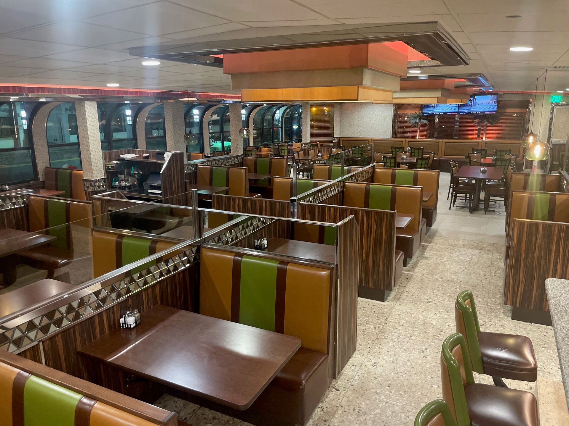 A restaurant with tables and chairs and a cactus in the middle of the room.