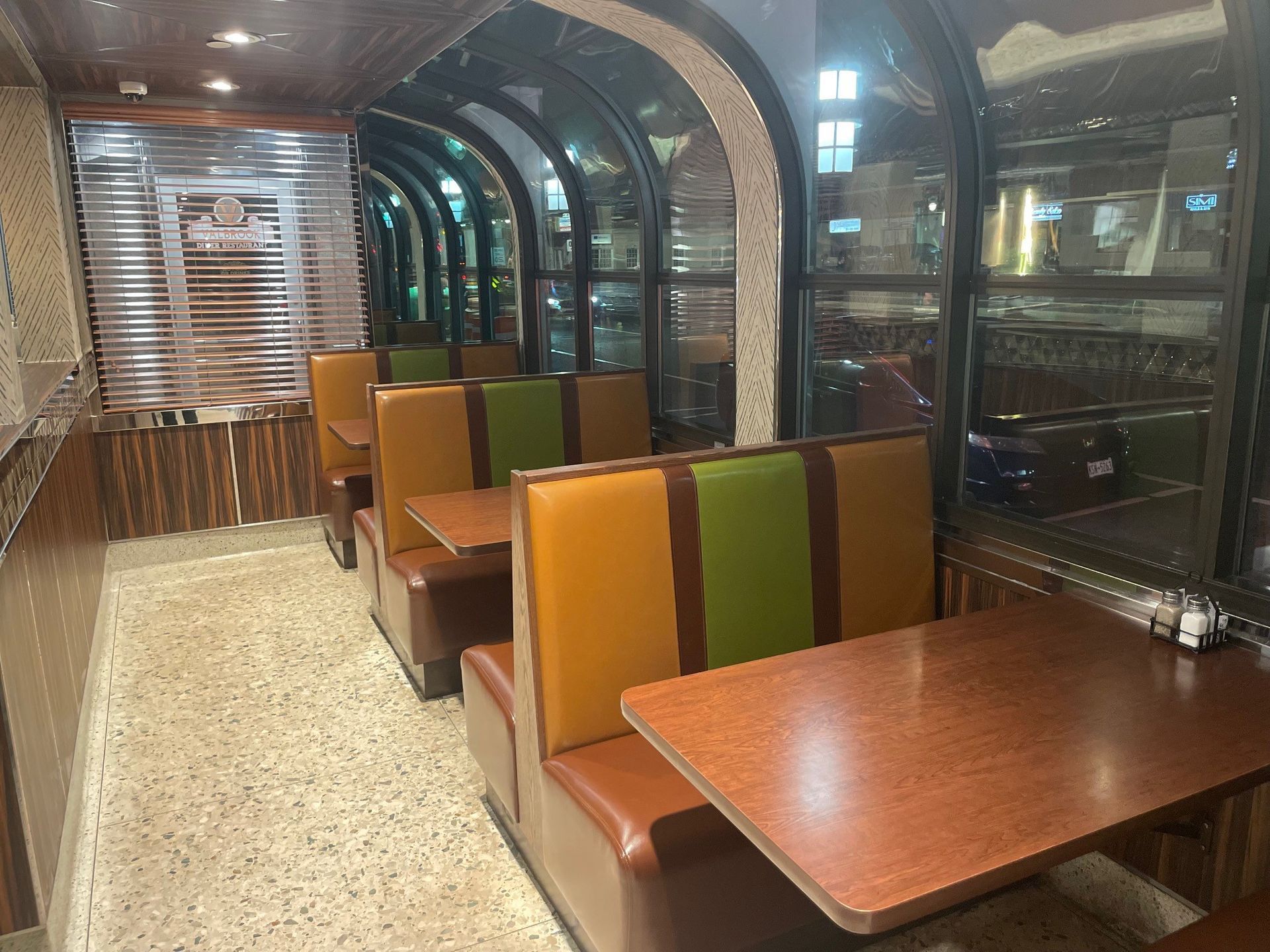 A row of booths with tables and chairs in a restaurant.