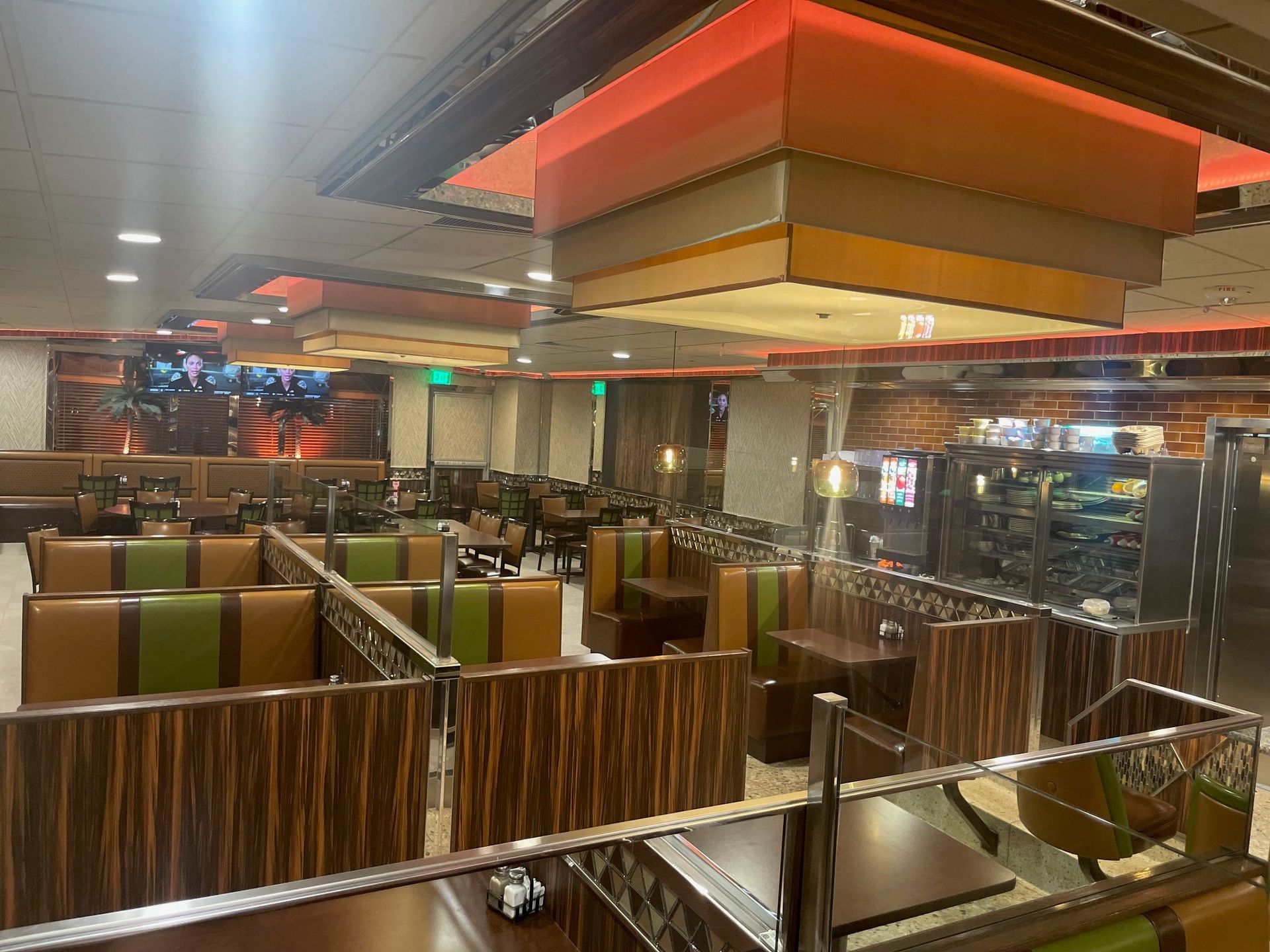 The inside of a restaurant with tables and chairs.