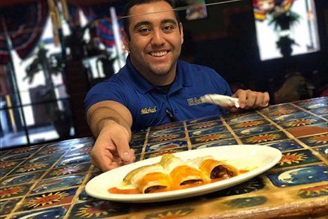 Employee serving mexican cuisine