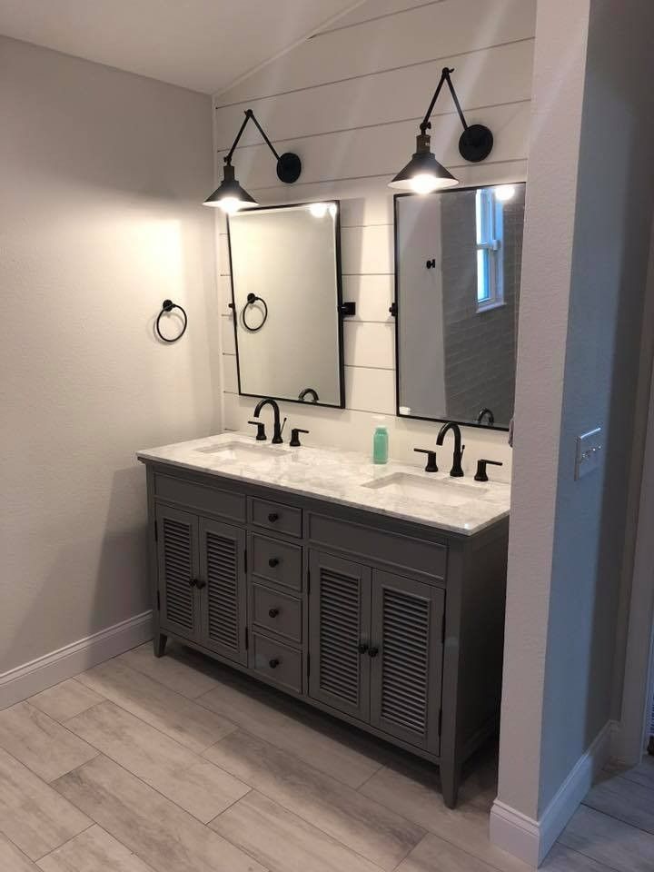 A bathroom with two sinks and two mirrors.