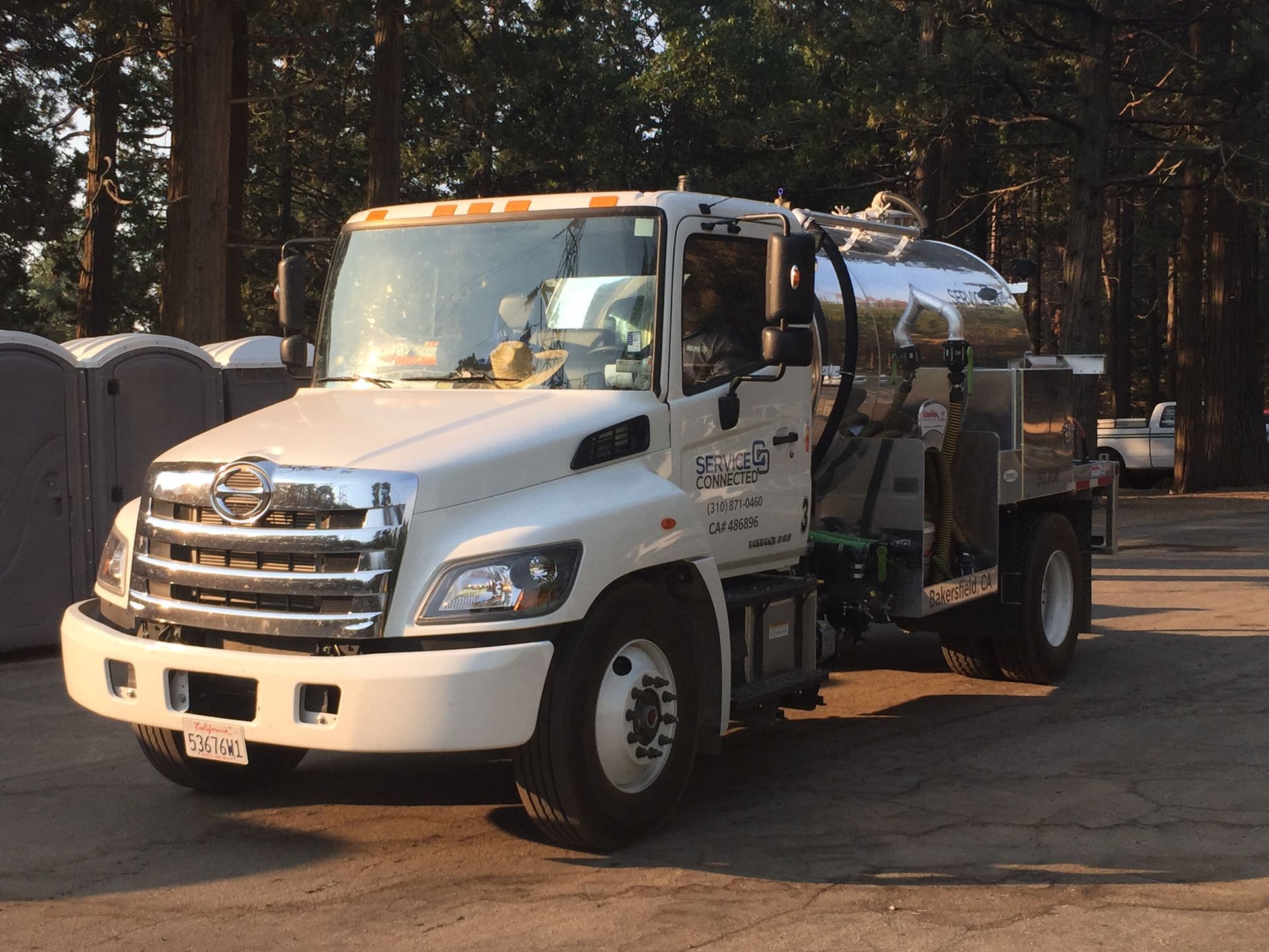 A Septic Connected truck parked near portable toilets