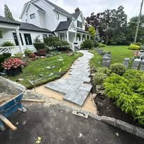 A walkway is being built in front of a house.