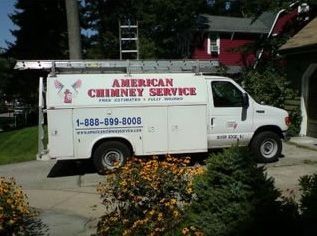 An american chimney service van is parked in front of a house