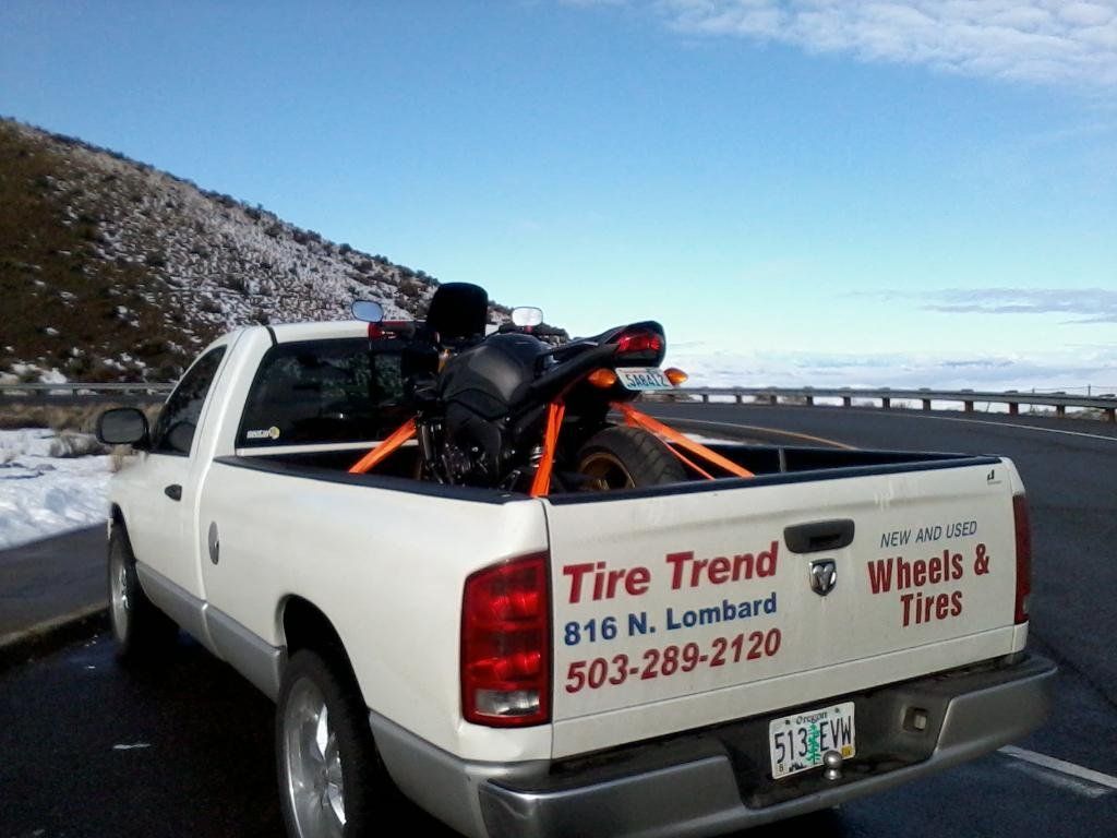 A tire trend truck is parked on the side of the road