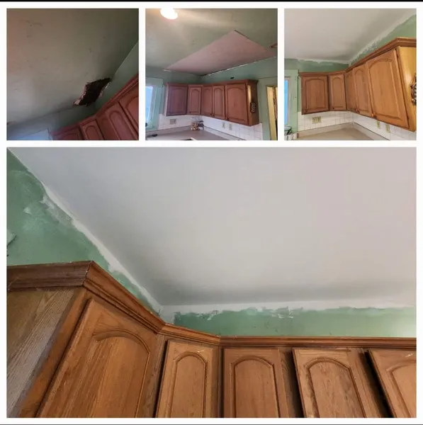 Kitchen ceiling peeling and sagging above wooden cabinets, with green water damage around the edges
