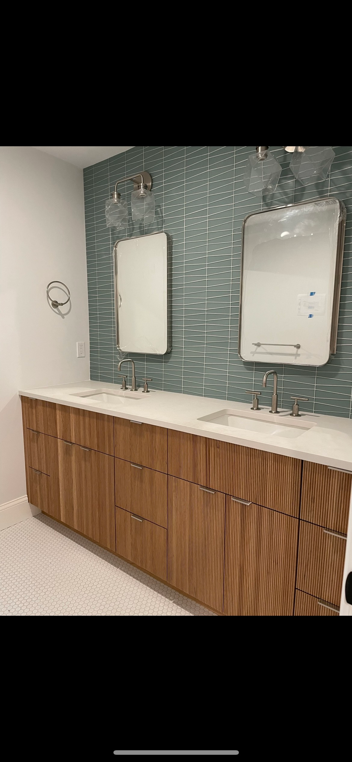 A bathroom with two sinks and a mirror.