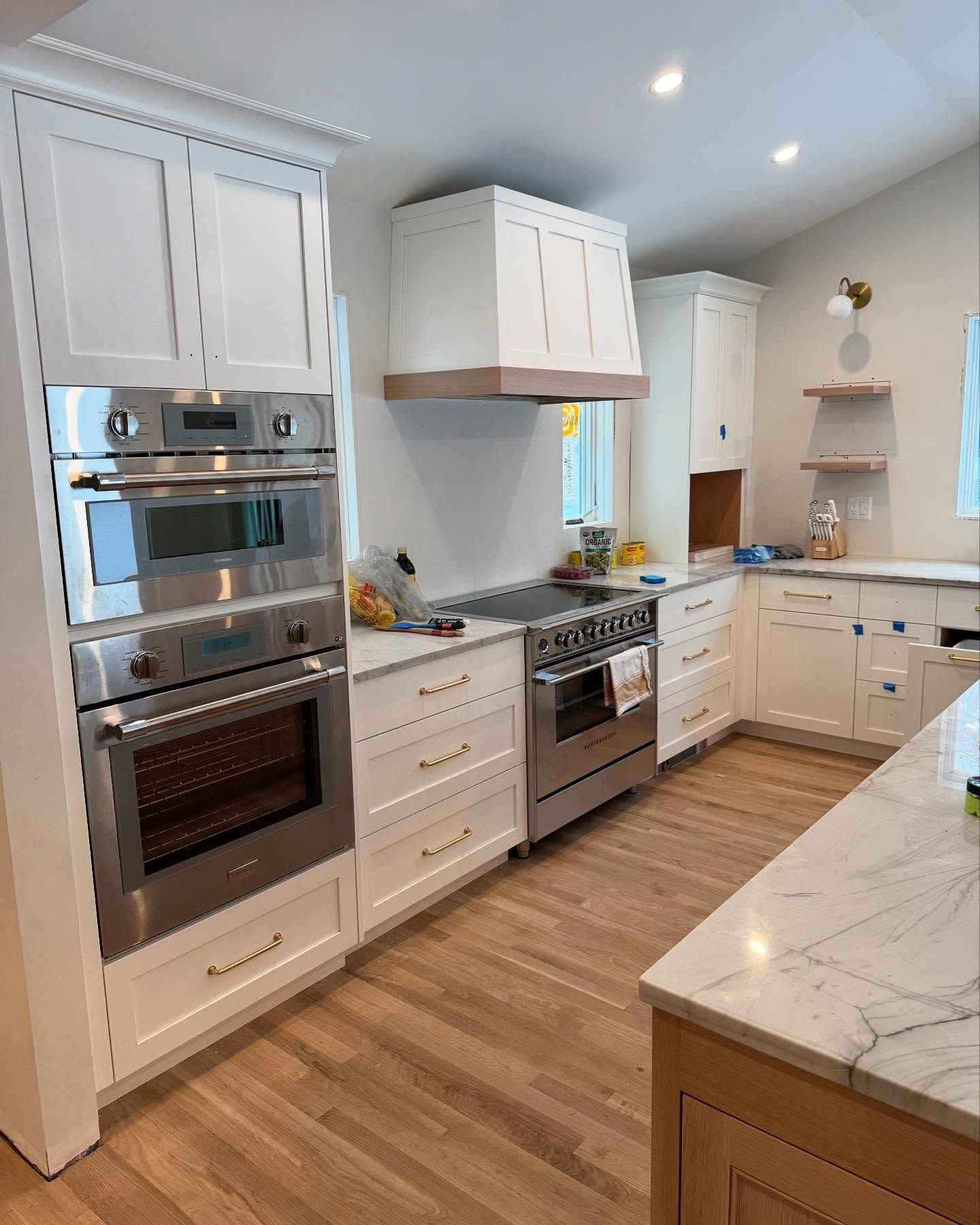 A kitchen with white cabinets and stainless steel appliances.