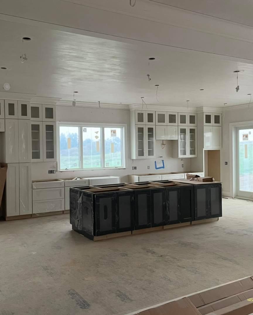 A kitchen under construction with a large island in the middle.