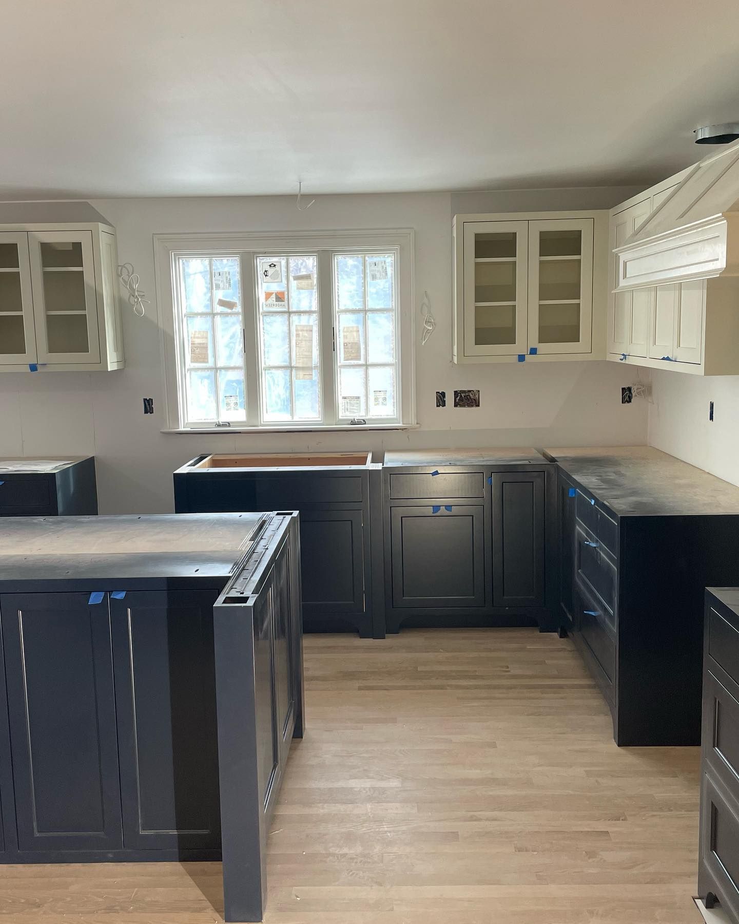 A kitchen with a lot of cabinets and a window.