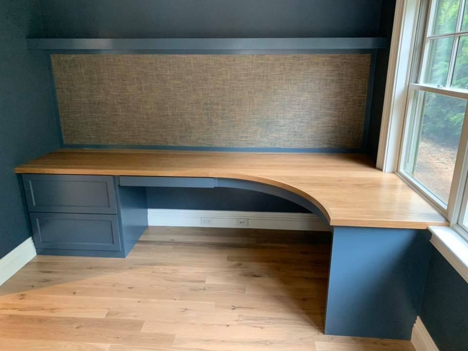 A large room with lots of cabinets and a desk.