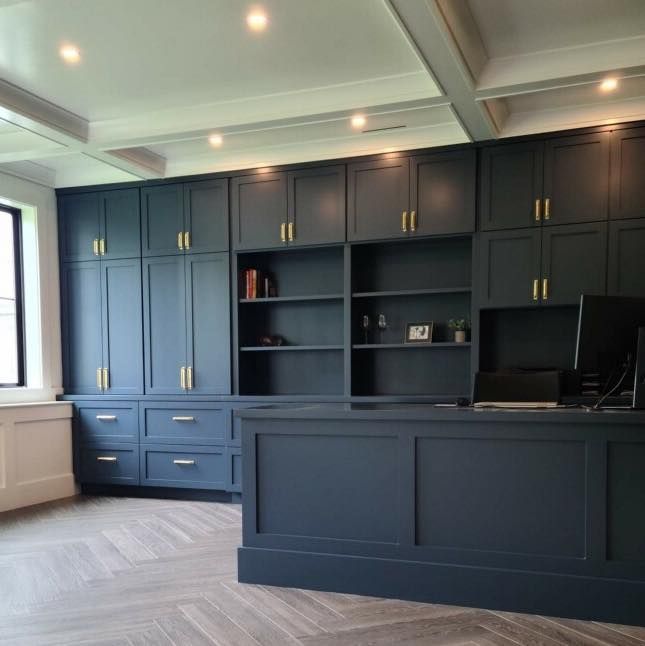 A large room with lots of cabinets and a desk.