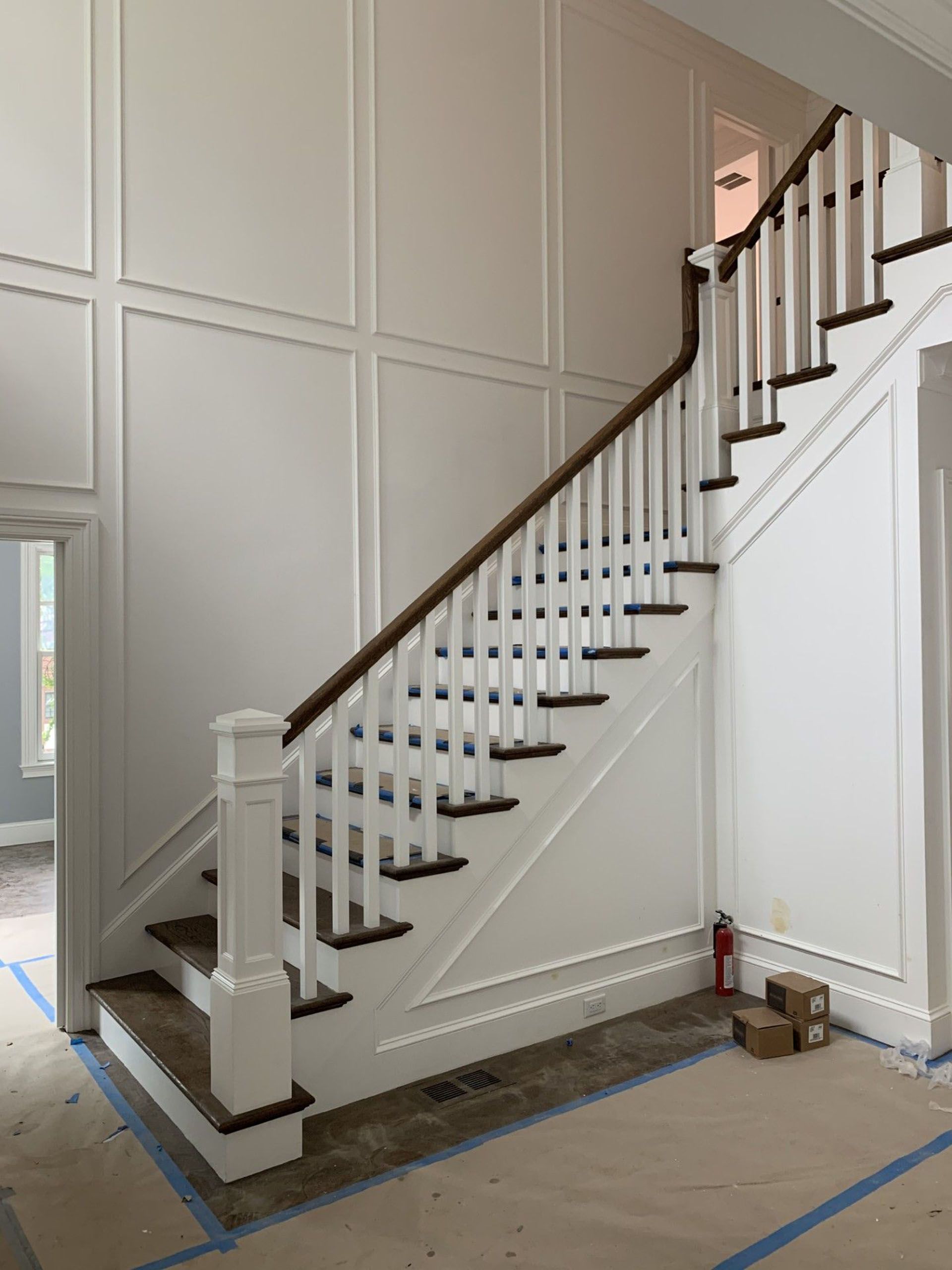 Staircase in a house with a wooden railing.
