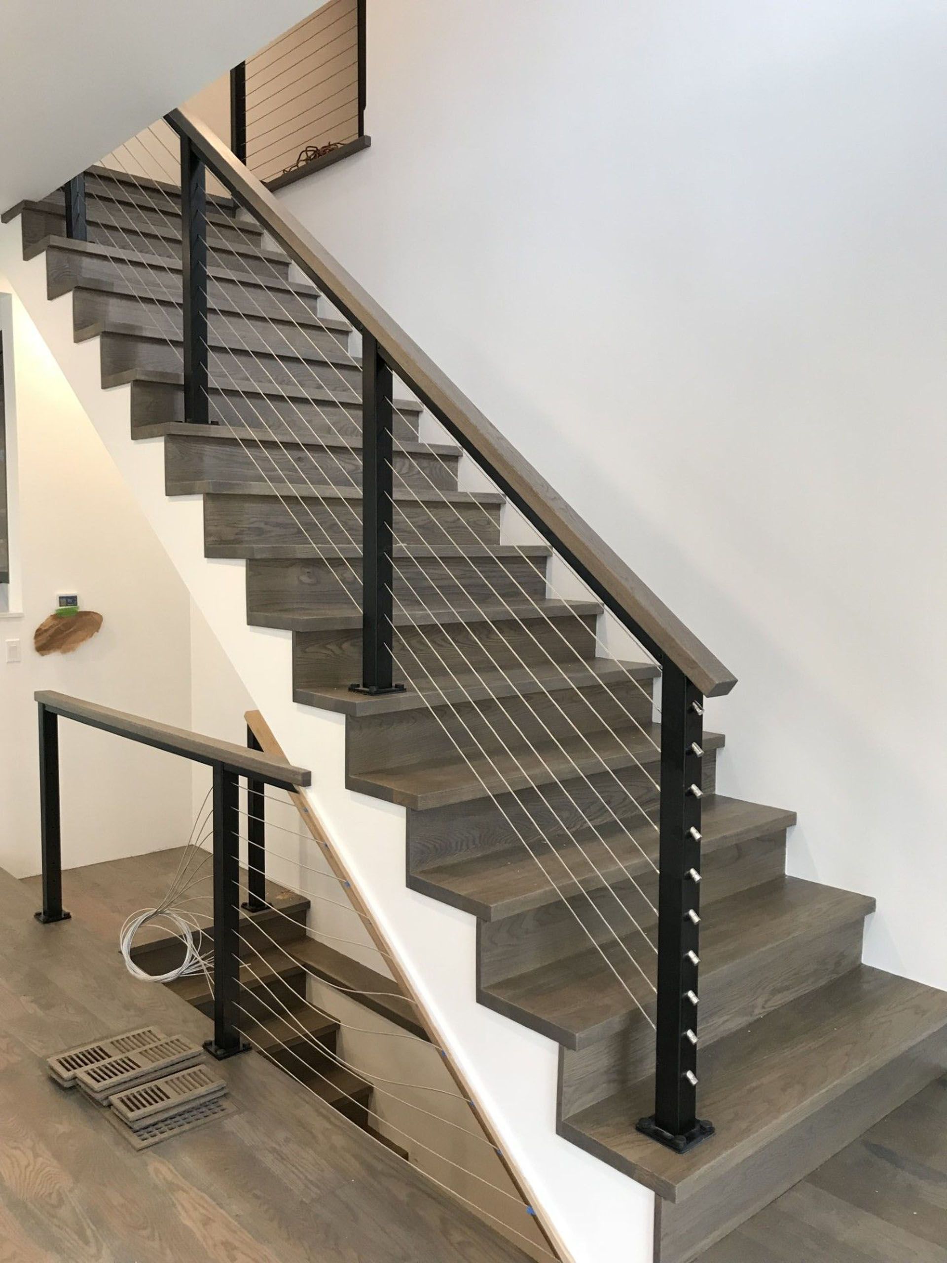 Staircase in a house with a wooden railing.