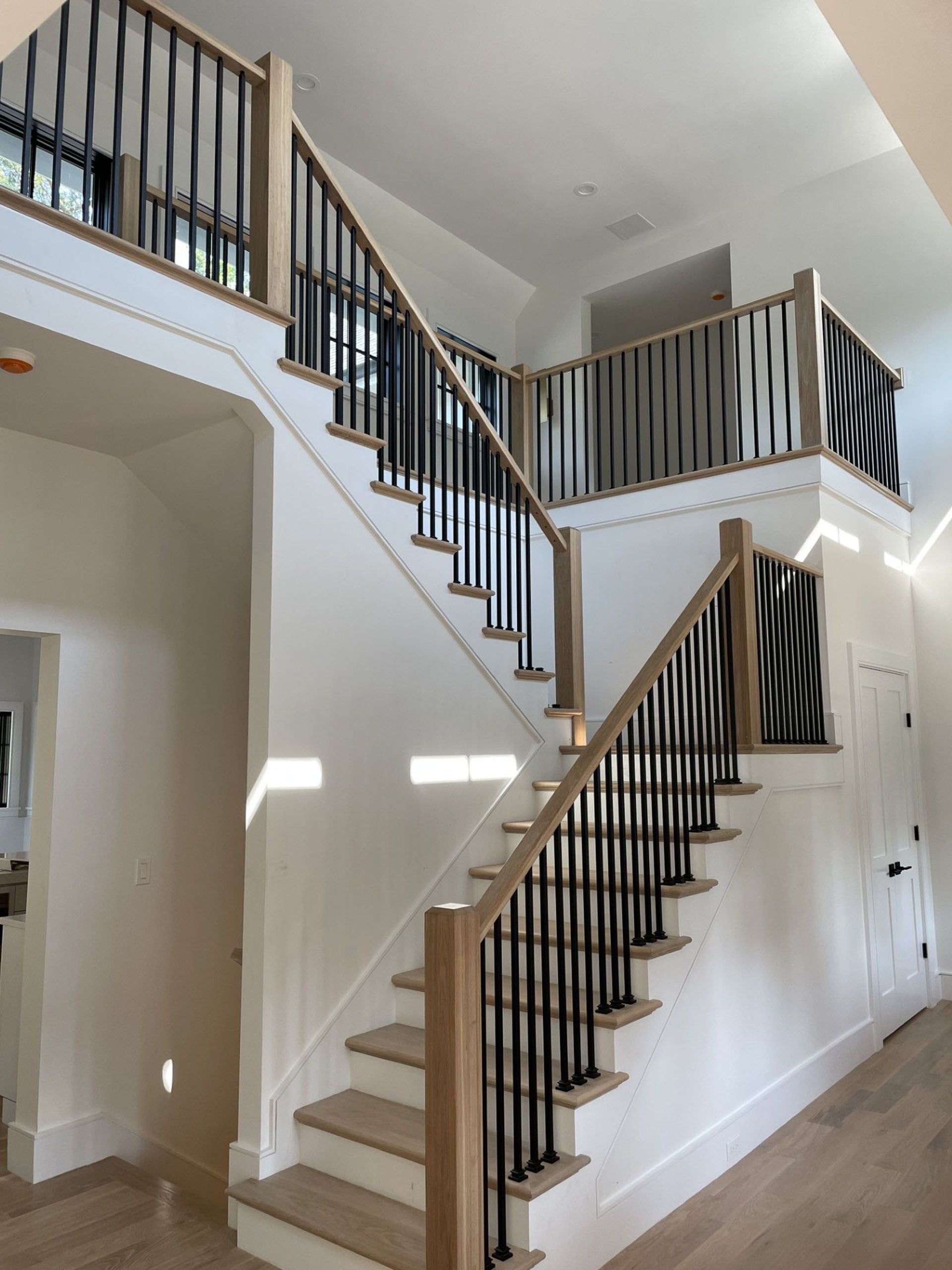 A staircase in a house with a wooden railing.