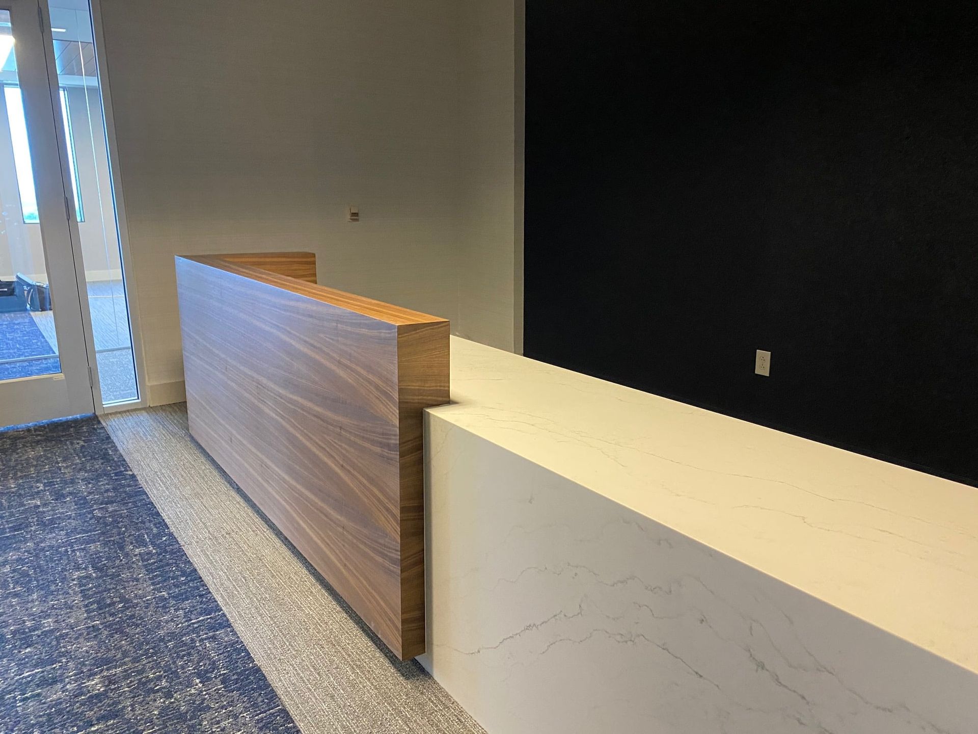 There is a long wooden counter in the middle of the room.