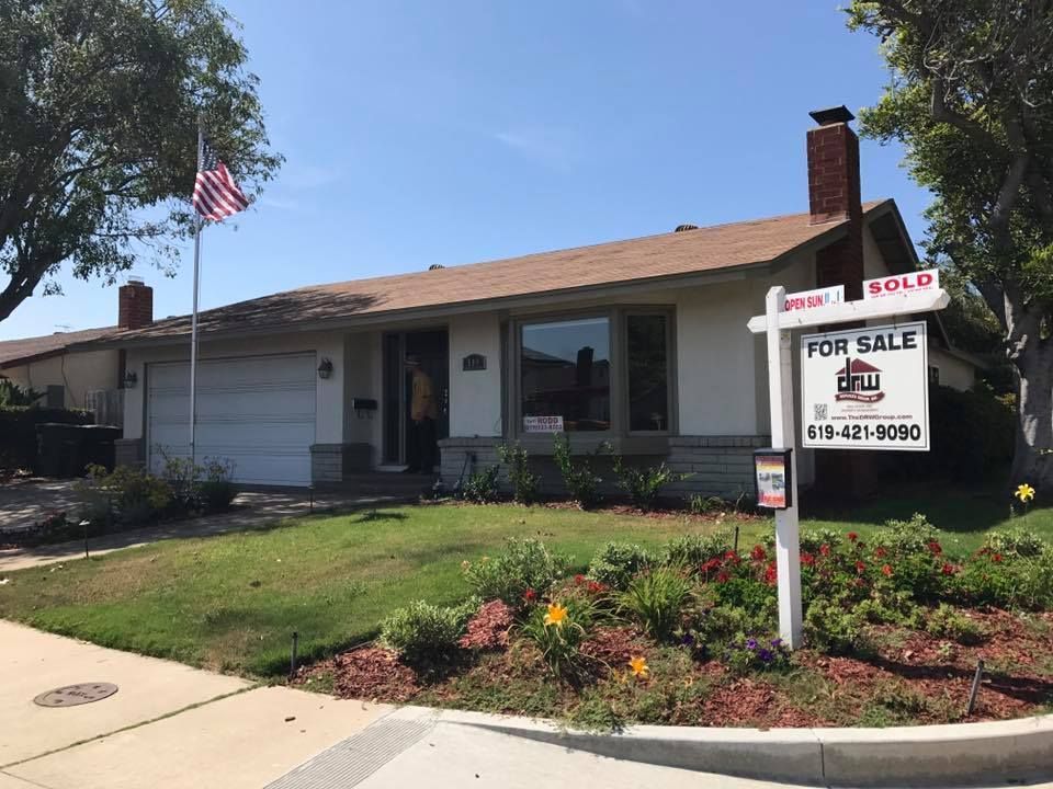 Single-story beige house with a garage, front lawn, and a 