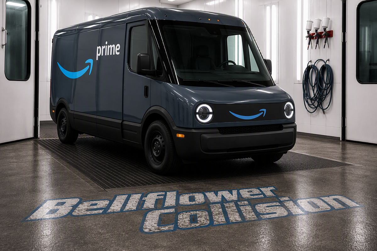 Amazon Prime delivery van in a garage, dark blue with logo and headlights on.