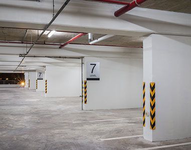 A row of empty parking spaces in a parking garage.