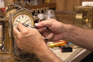 Man repairing the hands of a clock