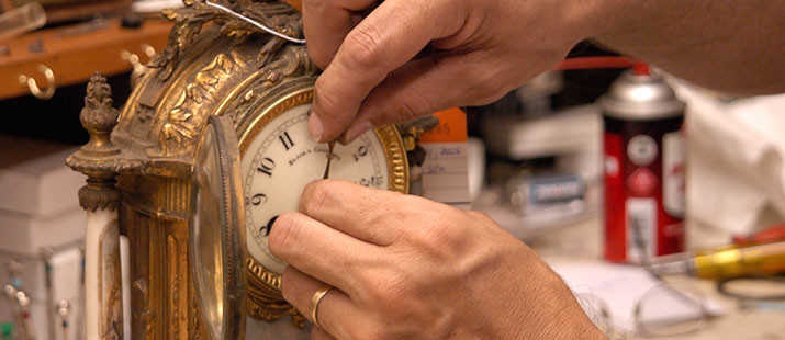 Hand fixing the hand of the clock