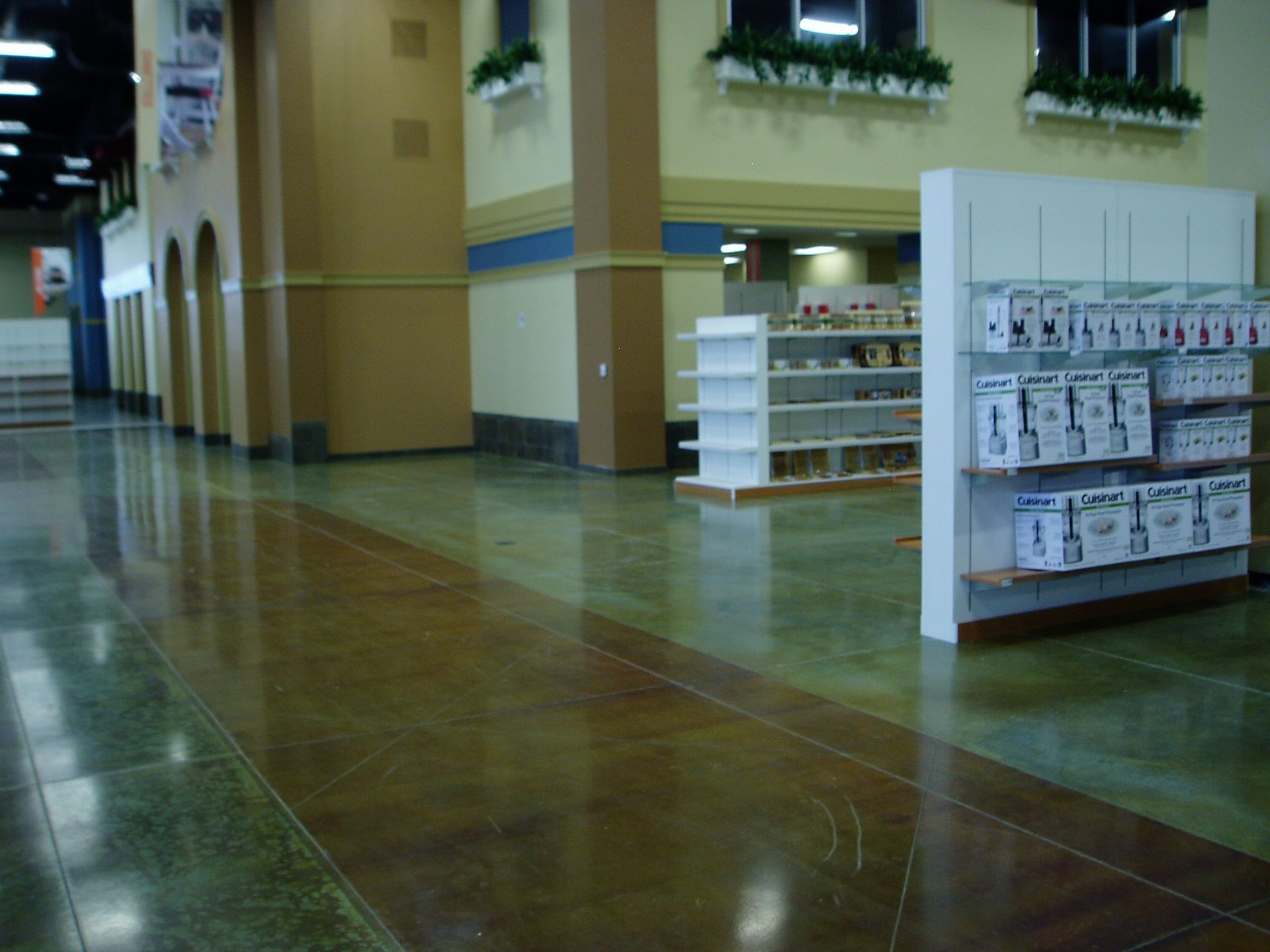 Polished concrete floor in a commercial space, with product displays and architectural details.