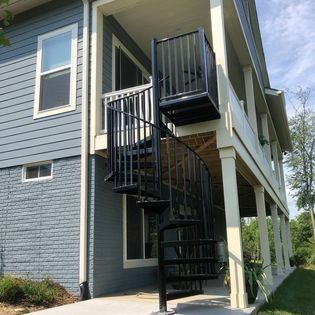 A house with a spiral staircase leading to the second floor