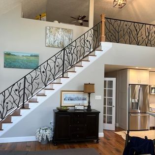 A living room with a staircase leading up to the second floor