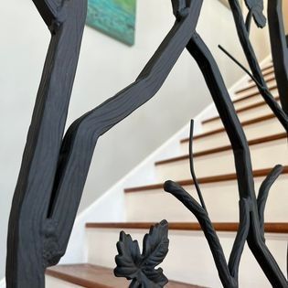 A close up of a wrought iron railing on a set of stairs
