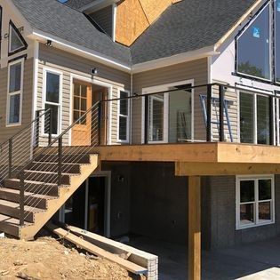 A house with a deck and stairs leading up to it