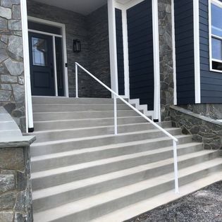 A set of stairs leading up to the front door of a house.