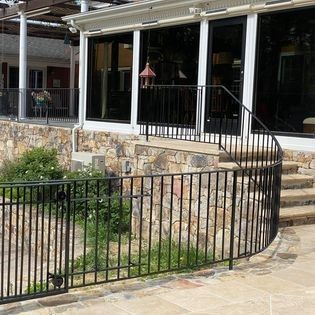 A building with stairs leading up to it and a fence around it.
