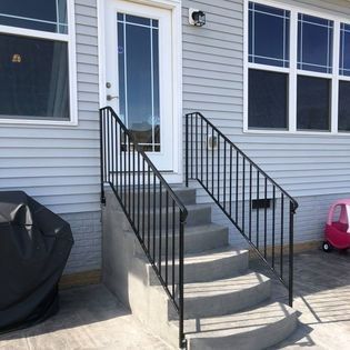A house with stairs leading up to the front door