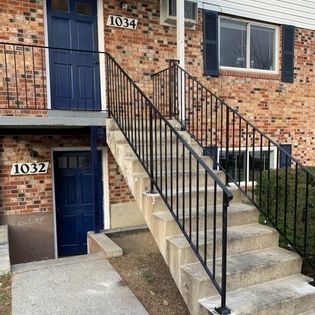 A brick building with stairs leading up to the second floor.