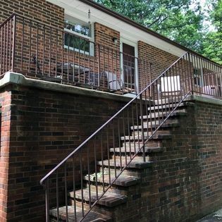 A brick building with stairs leading up to a balcony