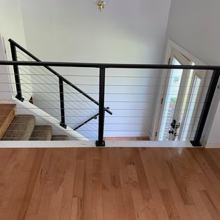 A view of a staircase from the second floor of a house.