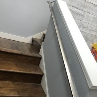 A staircase with wooden steps and a metal railing