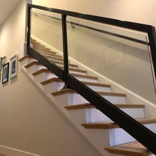 A staircase with wooden steps and a glass railing