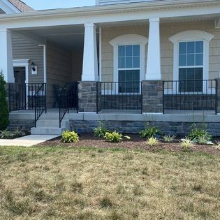 The front of a house with a porch and stairs