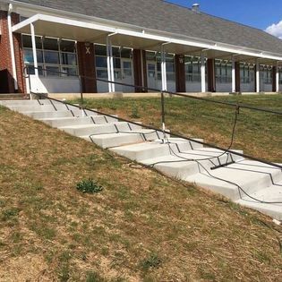 A set of stairs leading up to a building with a railing.