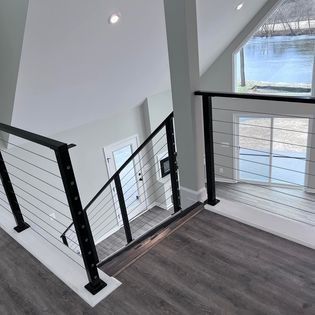 A large metal arch is being built in a garage.