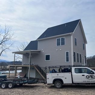A white truck is parked in front of a house.