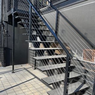 A set of stairs with a stainless steel railing