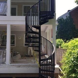 A spiral staircase is leading up to the second floor of a house.