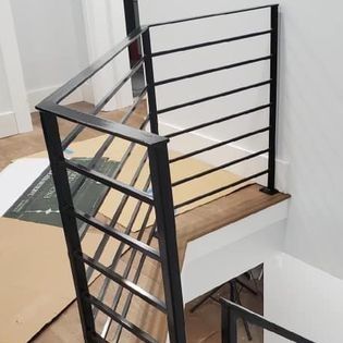 A metal railing on a staircase in a house.